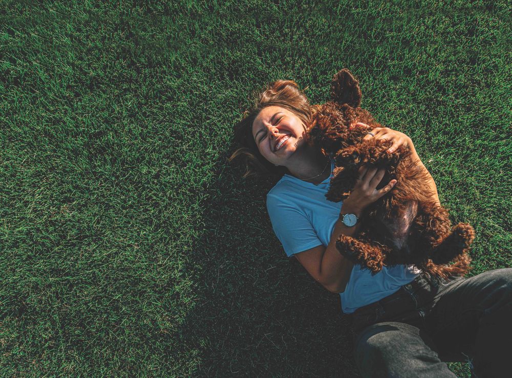 Girl_Dog_Grass_iStock-1350630614